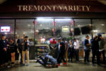 A man falls to the ground while standing in line to enter a nightclub.