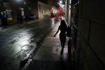 A woman walks along Lagrange Street in the Theatre District.