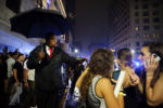 Doorman Orman Beckles, known as Orman the Doorman, encourages clubgoers to move on as they depart the Royale and Candibar nightclubs on Tremont Street.