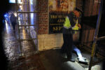 Boston Police Captain Robert Ciccolo checks on a man who had passed out on Tremont Street. The man was taken to the hospital by ambulance.