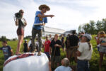 Judge Sam Fuller, Services Director of Northeast Organic Farming Association of Vermont calls out the winner of the Manure Relay event at the 2nd Annual Farmer Olympics.