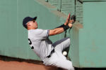 New York Yankees center fielder Jacoby Ellsbury (22) crashes into the wall trying to catch a double by Boston Red Sox shortstop Xander Bogaerts (2) during the seventh inning at Fenway Park Sept. 17, 2016.