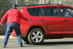 Boston Police officer in plain clothes, Scott O'brien points his gun at a Toyota suv that is taking off on him on the wrong side of Coumbia Road. The driver was being stopped for using the vehicle without authorization, and had prior gun charges. The driver sped away backwards striking O'brien, who then chased the vehicle as it drove down Columbia Road in the wrong direction The vehicle was lost in the pursuit and the driver was wanted for assault and battery on a police officer with a motor vehicle. The driver was captured a short time later.