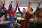 The Kingian Nonviolence Training program was held for 5th grade students at the Lowell Elementary School. Tim Connelly, 10, makes a screaming gesture as he and other students "shake it up" as they applaud the speaker with their arms up in the air. The students were taught about learning the early stages of agressive and offensive behavior, and body language.