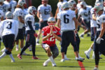 The New England Patriots held their first day of training camp at the practice field of Gillette Stadium as quarterback Tom Bdady holds a yoga pose while loosening up. Brady was allowed to practice with the team until his four game suspension for deflategate.