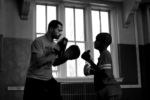 Boxing coach Russell Kimber works with student Keith Evans on his punching technique.