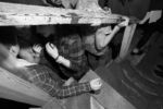 People talk amongst themselves next to the stairs while waiting for the next band. Valhalla, house venue in Allston