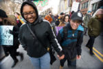 Liniște, right, a 22-year-old gay woman who is experiencing homelessness, walks with her girlfriend Tay at the Queer and Trans Liberation March in downtown Boston on Feb. 5, 2017.