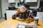 Liniște, a 22-year-old gay woman who is experiencing homelessness, eats her first meal in three days in the kitchen of the STEPS youth drop-in center in Arlington, MA on Sept. 27, 2016.