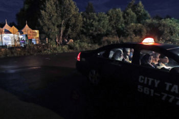 A taxi filled with women from many nations pay their fare as they arrive at an unofficial border station across from Saint-Bernard-de-Lacolle, Quebec on Roxham Road in Champlain, N.Y., early Tuesday, Aug. 8, 2017. The migrants are being driven north by the perception, real or perceived, that the age of President Donald Trump means the United States is no longer the destination of the world's dispossessed.