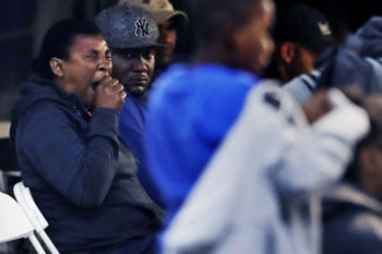 A woman yawns as she waits to be processed at an illegally crossing point, staffed by Royal Canadian Mounted Police officers, in Saint-Bernard-de-Lacolle, Quebec, in the early morning hours of Tuesday, Aug. 8, 2017. Seven days a week, 24-hours a day people from across the globe are arriving at the end of a New York backroad so they can walk across a ditch into Canada.