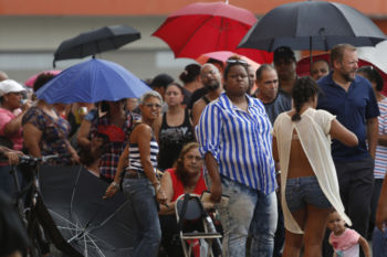 Caguas, PR -- 9/29/2017 - By 9:00 am more than 500 people were waiting in line to use the ATM outside of Banco Popular in Caguas. Without power what little supplies that were available here were dependent on cash. Long lines dominated cities like Caguas for fuel, food, water and even laundry.