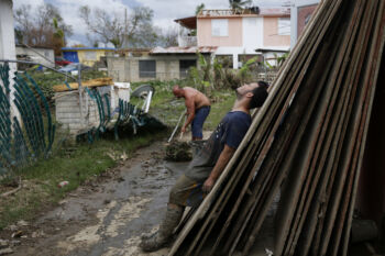 Toa Baja, Puerto Rico -- 9/30/2017 - Ten days after Hurricane Maria hit Puerto Rico Eric La Luz, 15, and his family were still doing the mentally and physically exhausting work of cleaning out their home. Almost everything in the home was a total loss but they were eager to move out of the shelter they were living in and back home. Using a rectangular plastic tub they dragged bin after bin of mud and debris out of their home in Toa Baja.