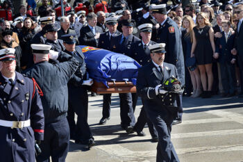 STORY SYNOPSIS:
The Massachusetts firefighting community and the Watertown community came together to mourn the loss of Firefighter Joseph Toscano during a funeral service at Saint Patrick Catholic Church in Watertown on March 22, 2017. Firefighter Toscano, 54, died on March 17 after he collapsed while battling a two-alarm fire on Merrifield Avenue. He had been a Watertown firefighter for two decades. He leaves behind his wife Maureen and five children ages 12-19.
CAPTION:
Fellow Watertown firefighters carry the casket of firefighter Joseph Toscano into Saint Patrick Catholic Church for a funeral service as firefighter Toscano's wife, Maureen, and five children, at right, look on, on Wednesday, March 22 2017.