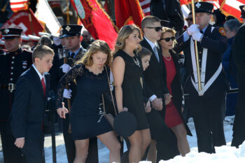 Maureen Toscano, right, the widow of fallen Watertown firefighter Joe Toscano, and her teenage daughters Alyssa and Mary Cate and sons Patrick, William and Michael file into Saint Patrick Catholic Church for firefighter Toscano's funeral service on March 22. Toscano, 54, died March 17 after he collapsed while battling a two-alarm fire on Merrifield Avenue. He had been a Watertown firefighter for two decades.