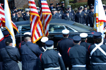 A limousine carrying members of the Toscano family passes by firefighters standing at attention on Main St. in Watertown following firefighter Joseph Toscano's funeral at St. Patrick Catholic Church March 22. Firefighter Toscano had been a Watertown firefighter for two decades and leaves behind five children ages 12-19.