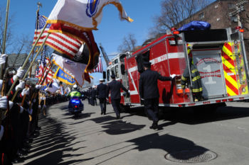 Watertown Engine 1, carrying the casket of firefighter Joseph Toscano, leaves St. Patrick Catholic Church following firefighter Toscano's funeral service March 22. Firefighter Toscano, 54, had been a firefighter for over two decades and leaves behind five children ages 12-19.