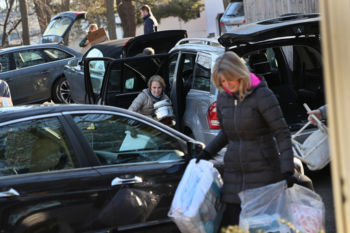 The Last Refugee: Through the Closing Door
3. Members of Temple Beth Elohim of Wellesley carried household items into the home they prepared for a family of six.The Hayani family moved in three days later. Settling Syrian refugees in Boston's western suburbs was an experiment the State Department and its partners had initially been reluctant to approve. The areaÕs high cost of living was considered risky for people already facing obstacles. Nevertheless, a small army of volunteers and community leaders was determined to try and make it work.