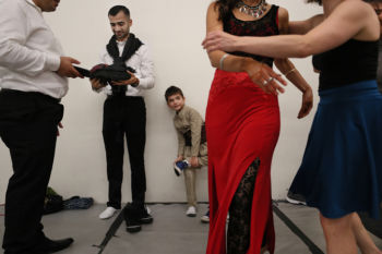 The Last Refugee: Through the Closing Door
10. In September, an invitation came from a modern dance company in Cambridge. Selmadance was planning a collaborative performance, with Muslim and Jewish dancers. They asked Abdulkader and the other Syrian men to dance with them. The night of the performance, Abdulkader and his sons waited back stage with the Jewish dancers.Ê
Abdulkader, left, had not danced the traditional Dabke, in 7 years. Every memory he had of it took him back to that lost world, before the war. His country was in ruins; his family scattered. People were still dying. How then could he dance?
Abdulkader made their costumes for the traditional Middle Eastern folk dance, the Dabke. He taught his boys the dance, as his older brothers had taught him. It was a link to their heritage and homeland, and it felt more precious now, as he watched his sons become American.