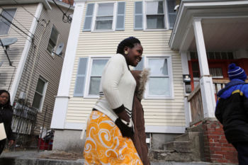 Nyirakabanza Muhawenimana smiles after touring outside her new home in Lowell.
ÒNow that we are in Lowell, this is our destination. We are finished,Ó said the oldest child, who took the lead in questioning workers from the International Institute of New England, the resettlement agency.
She asked whether the family could wash clothes in the tub. No, take them to a laundromat, replied case manager Sabyne Denaud, who emigrated from Haiti.
And so it went: Here is where the trash goes, make sure you lock the doors at night, do not let the children out alone, and call 911 on the apartment phone if there is an emergency.
ÒThis is the first time they have lived in a house,Ó said Suad Mansour, a Lowell High School teacher who was one of four people to greet the family at the airport.