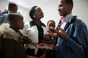 Nyirakabanza, center, and her siblings talk with Bertin Tuyizere, a minister with the Kingdom Hall of Jehovah’s Witnesses.
Approximately a dozen area Congolese have already joined Kingdom Hall of Jehovah’s Witnesses in nearby Chelmsford, said Markus Lewis, who is part of a church group that has learned Swahili to communicate with African worshipers.