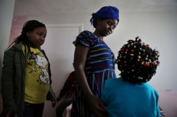 Vanisi, center, spoke with her daughters, Lea, 12, left, and Sarah, 7, as they arrived home from school in Lowell.
The challenges are daunting — the family does not speak English, for one. But regular follow-up will ease the transition to a strange country, said Tea Psorn, a program manager from the institute who came to the United States as a Bosnian refugee in the 1990s. “These people only want safety,” Psorn said.
