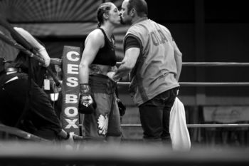 SYNOPSIS- Aleksandra Magdziak Lopes loves to win, but her April 7 fight was about family, and her preparation had been weighted with grief. Her husband and trainer, Wayne Lopes, had lost his son Manny on New YearÕs Eve. The 32-year- old had battled depression and drugs. When fight night arrived, ÒI wanted to do well for Wayne,Ó Aleksandra says. Her win in the match at Twin River Casino in Lincoln, Rhode Island, came after eight rounds. As the referee raised AleksandraÕs arm in victory, Òfor a split secondÓ she felt Òon top of the world.Ó And then she felt relief. Near the end of the evening, Manny, a promising boxer whose career was derailed by hand injuries, was honored by the promoter. Aleksandra wept. CAPTION- Aleksandra Magdziak Lopes kisses her husband and trainer, Wayne Lopes, before the eighth round of her bout with Paty Ramirez at Twin River Casino in Lincoln, R.I., on April 7. The 37-year-old, who lives in Marshfield, has become one of the worldÕs top-ranked female welterweights while working full time as a lawyer.
