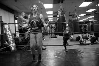 A week before her fight, Aleksandra jumps rope at BishopÕs Training and Fitness as 6-year-old Emerson Bishop, whose father owns the gym, watches. Aleksandra said she started sports at 7 years old. ÒI could play any sport you gave me,Ó she said. As an exchange student from Poland she went out for the football team and wrestled at Plymouth South High School, ÒthatÕs how I caught a bug for combat sports.Ó