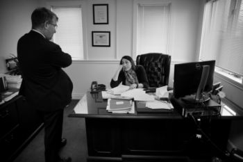 At work, Aleksandra talks with attorney John King in her Brockton law office at Babanikas, Ziedman King PC. As a lawyer she says sheÕs proud of her work. ÒI specialize in workersÕ compensation, on-the-job injuries, and I represent the employees side of the equation. So I feel like I get to deliver a very specific solution to my clients.Ó