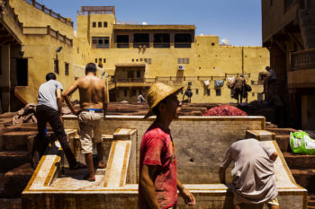Workers inspect hides at the Chouara tannery in the Medina in Fes, Morocco on July 29, 2017.