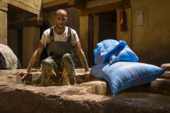 A worker softens hides in a white liquid by mixing the vat with his entire body before they can be dyed at the Chouara tannery in the Medina in Fes, Morocco on July 29, 2017.