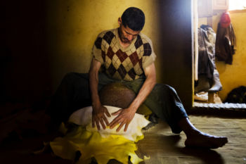 A worker hand-dyes hides yellow with saffron inside the Chouara tannery in the Medina in Fes, Morocco on July 29, 2017.