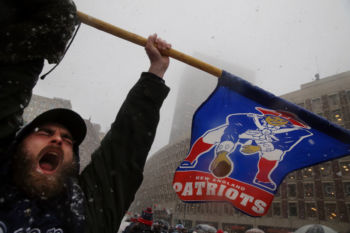 Nick Overbought of Lynn carries a flag during the New England Patriots Super Bowl LI victory parade.