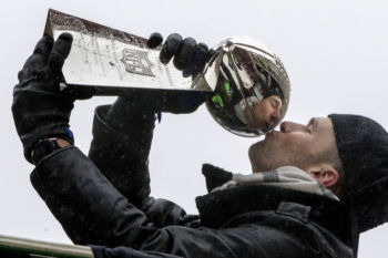 MVP Tom Brady kisses the Vince Lombardi Trophy as the Patriots Championship Parade makes its way down Boylston Street.