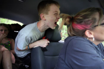 TITLE - Raising Connor
SUMMARY - He is moody and unpredictable. He is easy to love, affectionate, and friendly. Vulnerable, sweet, devoted to family. Impulsive, strong, and overflowing with emotion. Dreaming of home, always. Never quite at home, anywhere. This is Connor Biscan, a puzzle his family and caregivers have worked long and hard to solve, a boy who lives at the intersection of autism and mental illness. It isn't so much a rare place Ñ as many as half of autistic children suffer from mental health problems Ñ but it can be a deeply baffling one. The overlap between these afflictions is hard to untangle; diagnosis and treatment can be very difficult. And a health care system meant to help can instead be frustrating, even harsh.Ê
CAPTION - Connor yelled at his mother, Roberta Biscan, as they returned from an excursion during a family gathering in Nelson, N.H. Connor had shouted an expletive at his sister, resulting in his first warning from his mother for the weekend. Ten warnings and Connor has to return to his residential facility. He begged his mother to take it back. "Take it back, please take it back," he screamed in his mother's ear.
Connor is a child who struggles to manage his powerful reactions to disappointments, often taking out his anger on his mother.