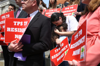 Patricia bends down to kiss her daughter, Camila, as they take part in a rally at the State House held to protest the Trump administrationÕs decision to end TPS for Honduras. When Patricia took her turn at the microphone, she spoke to the crowd from her heart, telling them an abbreviated version of her story: That she is an immigrant here legally, not a criminal. That she is a single-mother who works construction to provide for her daughter. That she loves this country.