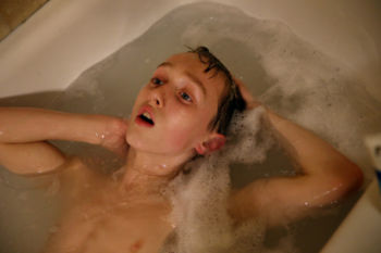 Connor soaked in the bathtub at home. He has been diagnosed with autism, a mood disorder, and attention deficit hyperactivity disorder. As many as half of children with autism also have a mental health disorder, and the combination makes treatment more complicated.Ê