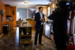 In just his socks, Democratic presidential candidate Andrew Yang, a former entrepreneur and tech executive, talks to a reporter at the Fassi family home in Goffstown, N.H., on Jan. 11, 2019. Yang selected Jodie Fassi to receive $1,000 per month for one year to illustrate Yang's Freedom Dividend, a universal basic income program.