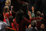 Deb Haaland (top R), wearing traditional Native American attire, takes the oath of office to become one of the first two first Native American women in the U.S. House of Representatives in Washington, January 3, 2019.