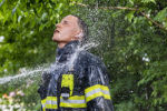 Brockton firefighter recruit Alexander Fontes, 25, is hosed off after a training exercise left him covered in debris on Thursday, May 2, 2019