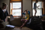 BIDDEFORD, ME - 07/13/2019 Mariah LeMieux-Lupien organizes paperwork while Evan, center, and Dylan play on the couch. "You just try and do everything right and then 'pftt', you're out," says Mariah, while sorting through her papers detailing her children's behavioral charts and progress. "It was really hard going through all the school work from the kids," Mariah reminisced. "How happy and hard they've all worked. They're kicking ass while I'm barely hanging on as an adult." All four of Mariah's children have special needs and she has kept a methodical archive of her children's education and special care over the past several years. While living in Northern Maine, the children were not receiving the education that they needed, which brought the family south to Biddeford. After about two years of living in Southern Maine, they are now faced with homelessness after spending several months teetering on a precarious financial cliff. Although Patrick Lupien, Mariah's husband, has a job working as an IT consultant, they are not able to make ends meet due to the great divide between what he is being paid and the cost of living. With nowhere else to go, the family has reserved a spot in a campground for the unforeseeable future.