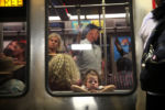 JULY 24, 2019: A young girl peers from a Red Line train at South Station in Boston, Mass., United States. A century ago, nearly 40 million travelers passed through the station every year.