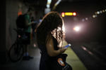 JULY 24, 2019: Sara Gautier, from Cambridge, waits for her train at South Station in Boston, Mass., United States.
On January 1, 1899, South Station opened to the public as one of the world's largest rail stations. It became one of the busiest in the country in the early 1900s. The bustling station that was first home to train service now also gives access to the MBTA subway and bus terminal.
