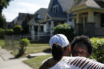 Milwaukee, WI, 08/19/2019 -- Stacy Hodges Harmon hugged Kenya Riley (L) a civic ambassador with Black Leaders Organizing for Communities or BLOC as Kenya walked door to door trying to organize the neighborhood and see what people needed. Harmon has lived all her life in Milwaukee, a city that Democrats have deemed so important to their chances of reclaiming the White House in 2020 that they will hold their convention here. But it is also a place with a knot of problems that has left voters like Harmon feeling deeply doubtful about the will in either party to help them. ÒA lot of these politics, and things that they discuss, donÕt pertain to me. I honestly think thatÕs why a lot of people donÕt vote,Ó Harmon said. ÒI vote every year, but I do feel like that Ñ why am I doing this? Why am I standing in this long-ass line when I know nothingÕs going to change to help me?Ó