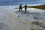 Mike Santos from Plymouth and his girlfriend Natashia Phelan from Fairhaven try to escape the fast-moving surf that caught them off guard as they walked along Nauset Light Beach in Wellfleet. Hurricane Dorian gave a glancing blow to Cape Cod, as high tide in the early morning brought 15-20 foot waves along Nauset Light Beach. The Cape Cod Commission studying the impact of a major hurricanes found that some 20 percent of Cape Cod, 70 square miles would be inundated during a hurricane.