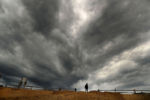 The leading edge of storm clouds from Hurricane Dorian look ominous above the sand cliff leading to Newcomb Hollow Beach in Wellfleet. The Cape has seen past Hurricanes cause extensive damage and erosion to beaches and waterfront homes.