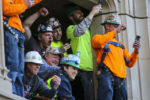 Construction workers cheer during the New England Patriots Super Bowl LIII victory parade in Boston on Feb. 5, 2019