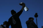 Tom Brady holds up the Super Bowl trophy during the Super Bowl Parade on Tuesday afternoon.