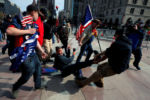 Demonstrators remove a counter-demonstrator during a rally in support of U.S. President Donald Trump sponsored by Super Happy Fun America, in Boston, Massachusetts, October 18, 2020.