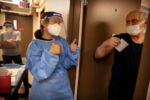 CENTRAL FALLS, RI - 12/30/2020: Dr. Katie Fleming offers a double thumbs-up to resident Mike Descote after he received the Moderna COVID-19 Vaccine at his home at Forand Manor in Central Falls, RI. A vaccination drive began at two high rises run by the Central Falls Housing Authority. Plans called for administering 300 doses of the Moderna vaccine to residents and staff at Forand Manor and Wilfrid Manor.